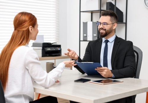 Immigration.,Woman,Having,Interview,With,Embassy,Worker,In,Office